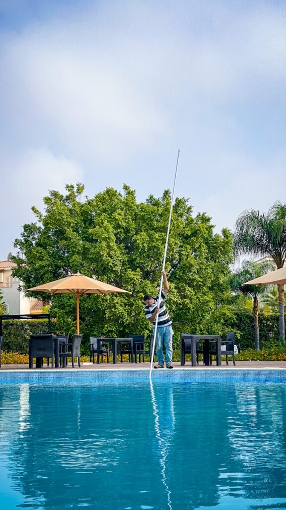 Professional pool cleaning team in action at a residential pool in Summerfield, NC near me.