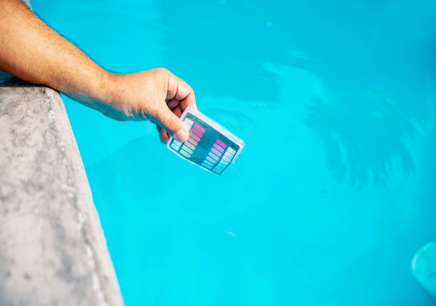 Triad Pool Management LLC checking pool pH levels in Greensboro, NC.
